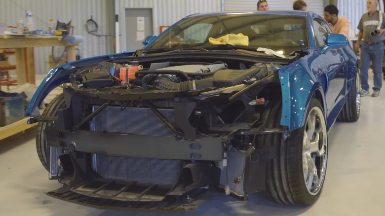 Trans Am Worldwide workers push unfinished Trans AM model in workshop