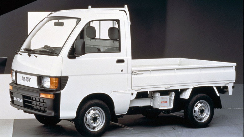 Studio photo of a white 1994 Daihatsu Hijet kei truck