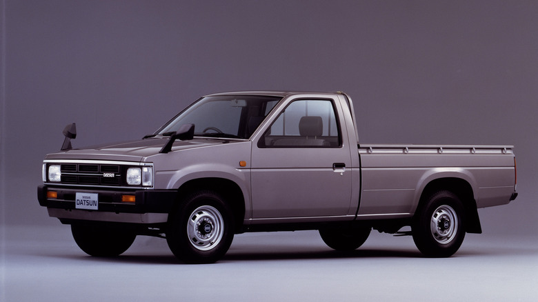 Studio photo of a 1985 Nissan Standard Body 2300L Diesel with a gray background