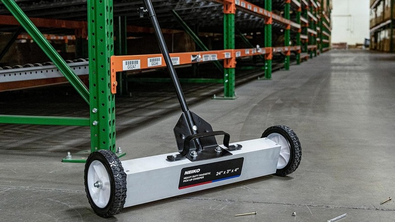 Neiko magnetic rolling tool in a warehouse with screws on the floor