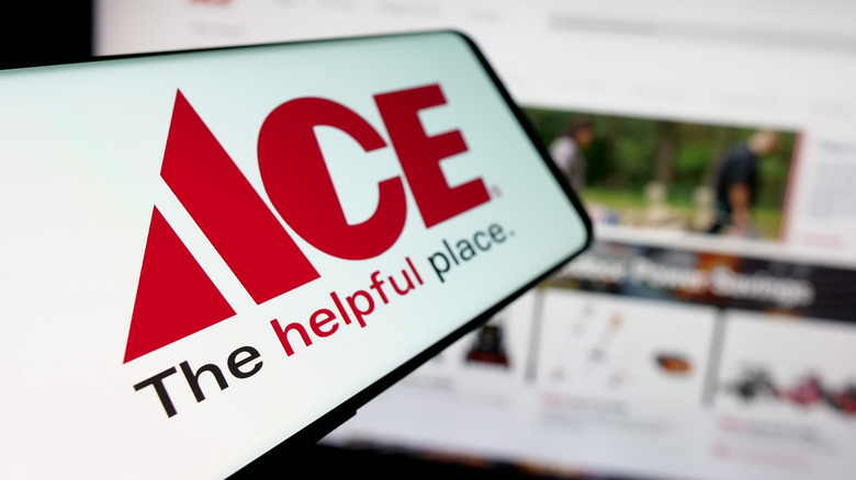 The Ace Hardware logo on a phone in front of the Ace Hardware website