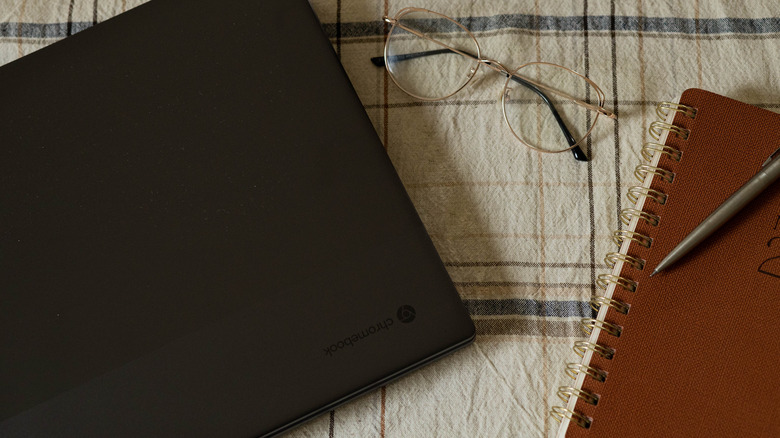 Acer laptop with glasses, journal