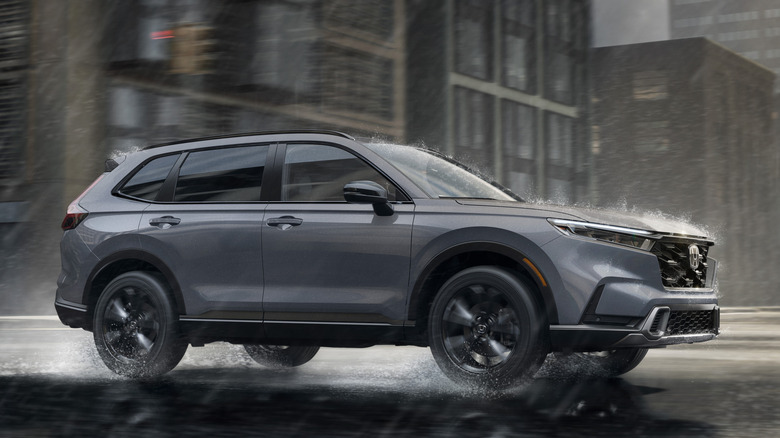 Front 3/4 view of Honda CR-V in rainy city setting