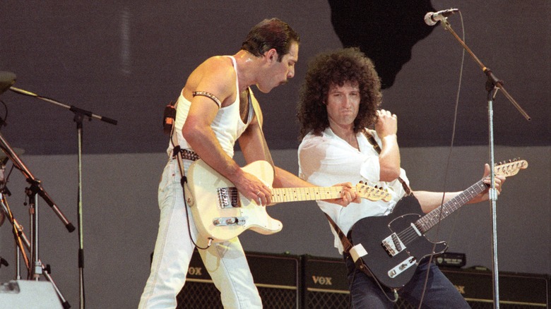 Queen rocks out during their iconic MTV Live Aid concert broadcast.