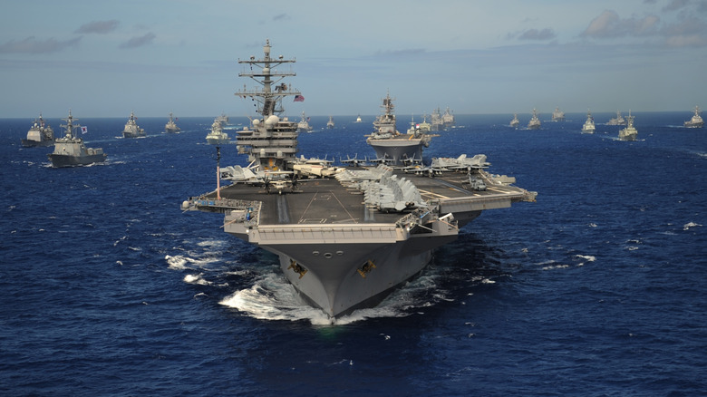 aircraft carrier and support vessels sailing