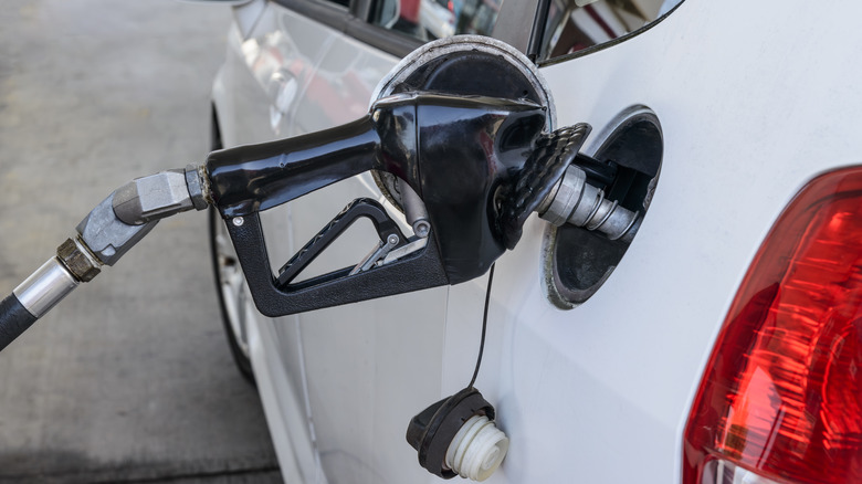 Gas pump pumping gas into car's tank