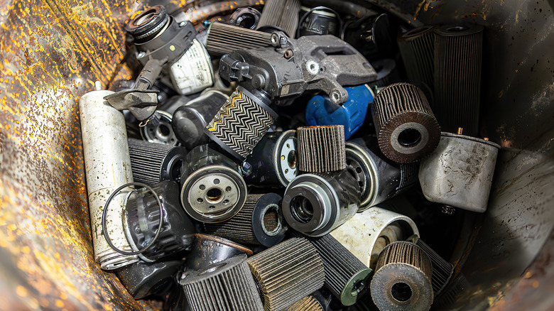 A collection of various types of oil filters in a pile