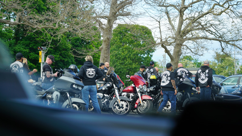A biker gang parked in the town center on a sunny day