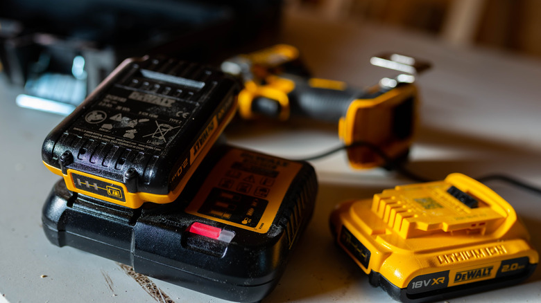 DeWalt batteries on and beside a charger.