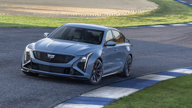 A close-up view of a gray Cadillac CT5-V Blackwing on a track, front 3/4 view