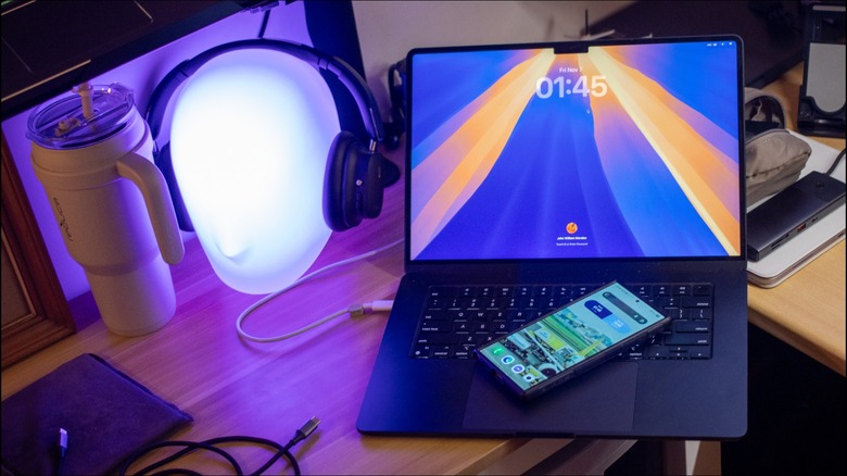 a Samsung S24 Ultra placed on an M2 MacBook Air on a desk