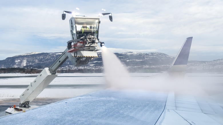 Jet wing sprayed with de-icing chemicals