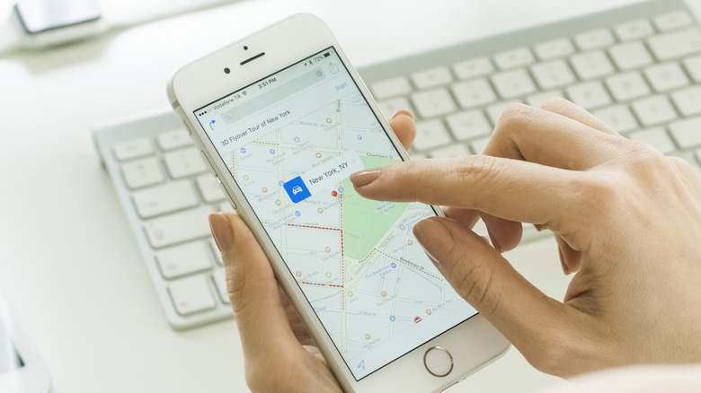 Woman using the Appke Maps app on her iPhone.