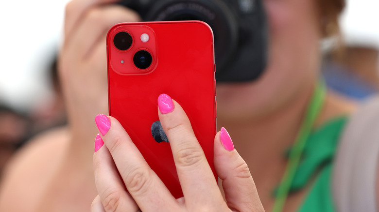 iPhone 14 red in hand