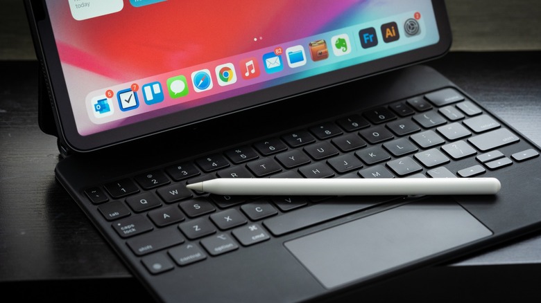 Apple Pencil resting on an iPad with a folio case