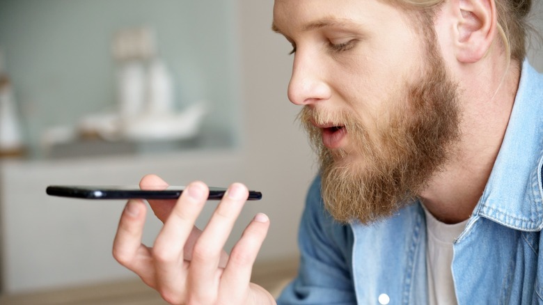 Person speaking into smartphone