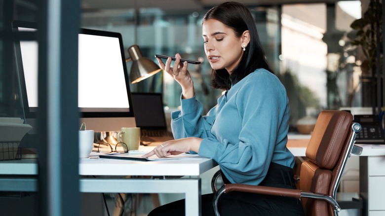 Office worker speaking into a phone