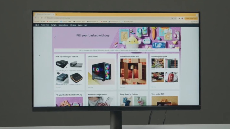 An Amazon Basics monitor on a table showing Amazon home page