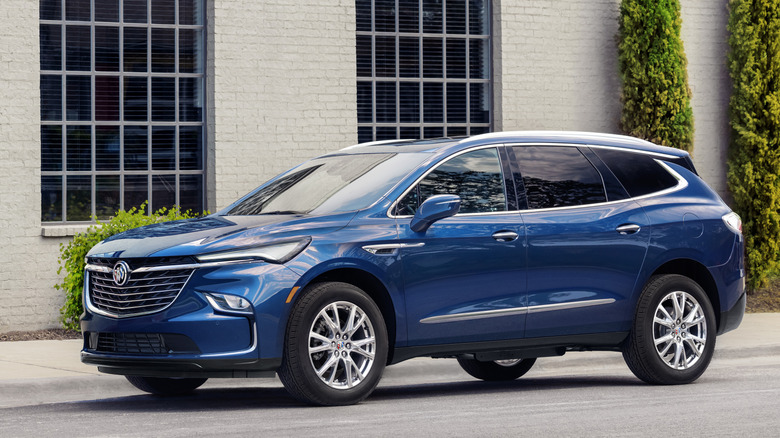 Blue 2024 Buick Enclave parked in front of building