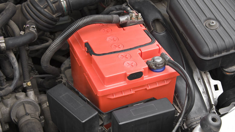 A car battery installed in an engine bay