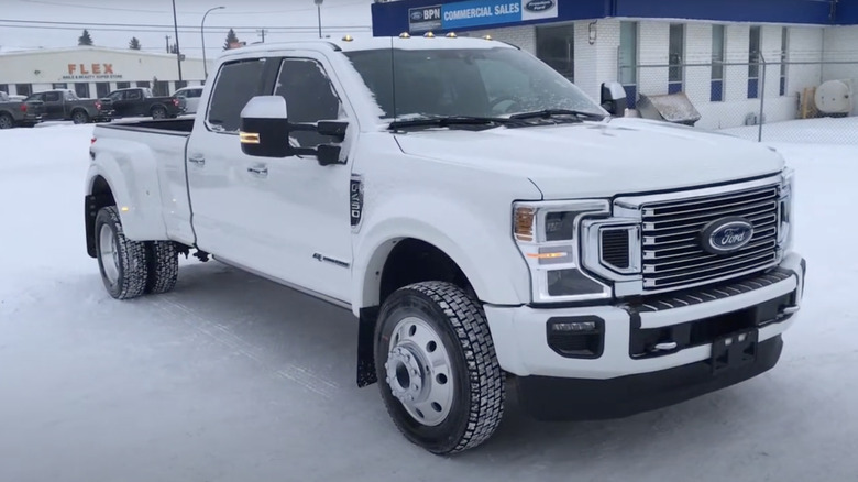 A white Ford F-450 dually parked on snow.