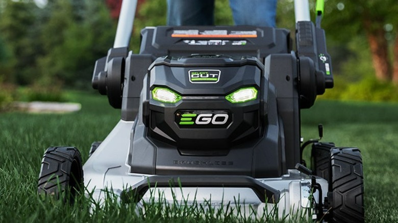 An Ego lawn mower pushing through grass.
