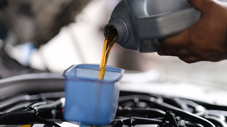 Pouring fresh oil to an engine