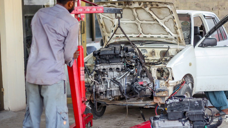 Car engine being swapped