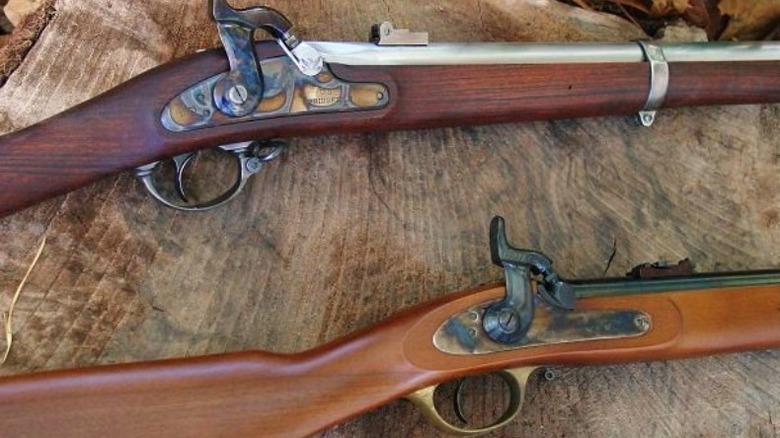 Two guns on wooden surface