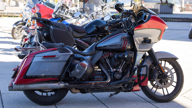 Custom Harley Davidson motorcycle stands out in a lively outdoor area