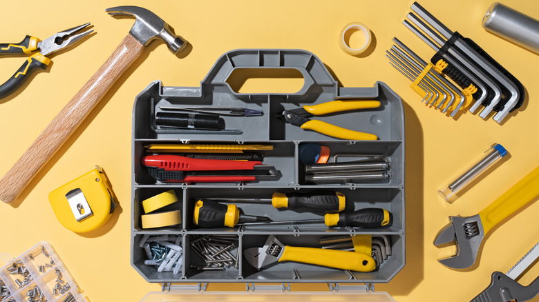 An open toolbox surrounded by loose tools.