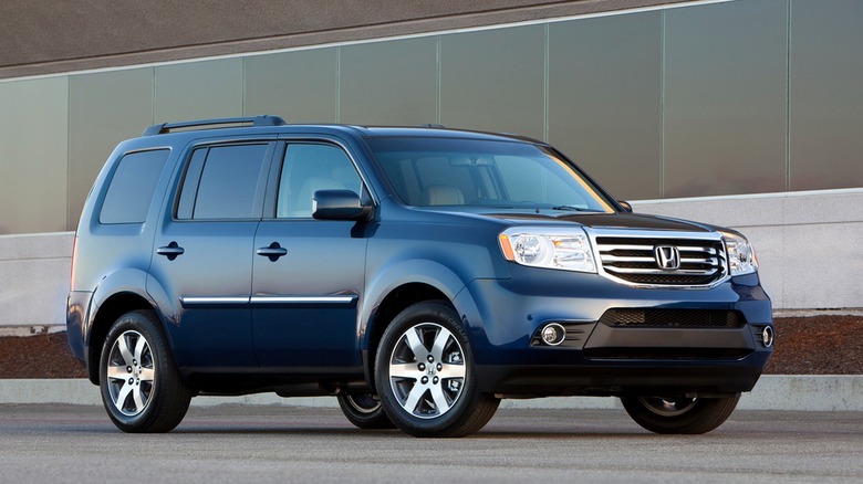 2012 Honda Pilot In Dark Blue In Front Of An Office Building