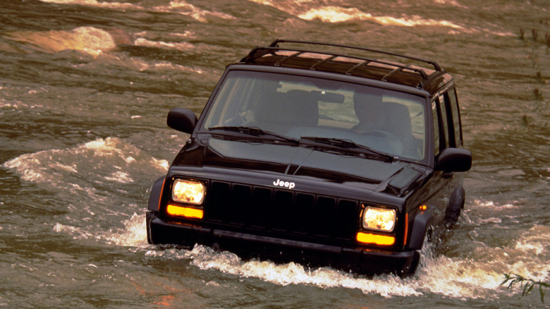 1997 Jeep Cherokee wading through river with water at tire-height