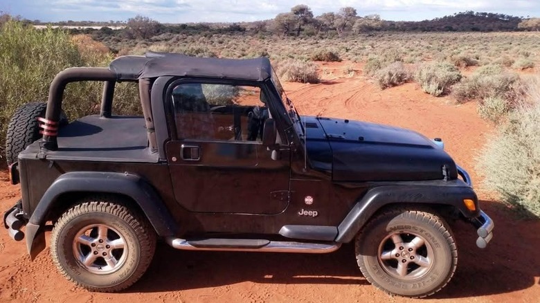 Side view of a Jeep Wrangler TJ in Australian outback.