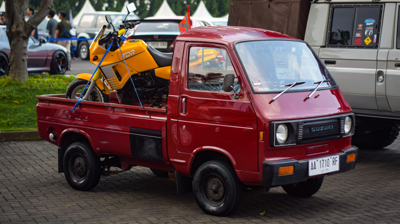 A red Suzuki Carry ST20 kei truck.
