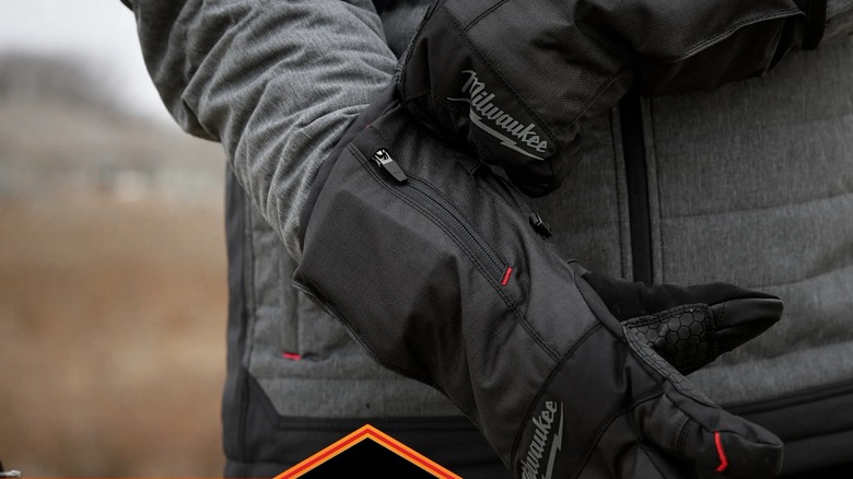 Close up of a pair of Milwaukee winter gloves being pulled on outdoors