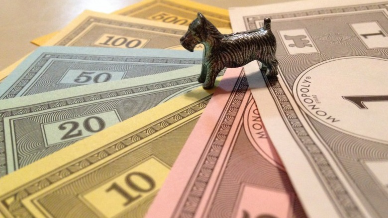 Toy game piece on Monopoly money