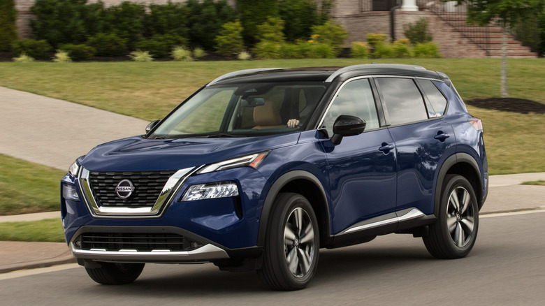 2021 Nissan Rogue driving down suburban street