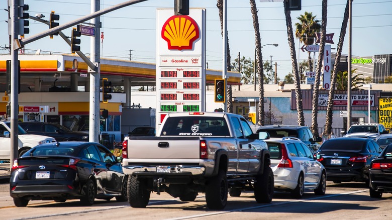 Pickup truck sits in Los Angeles traffic in front of a petrol station