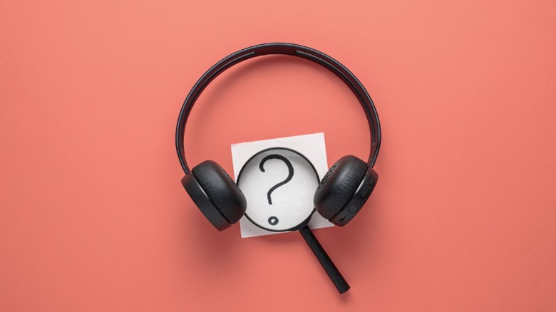 Magnifying glass between a pair of headphones