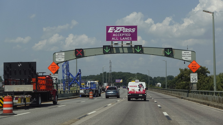 Vehicles approaching the different lanes on a toll road.