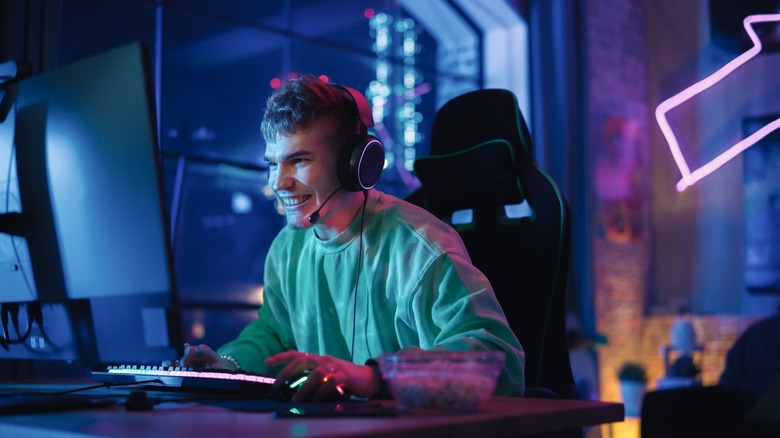 Individual gaming at a PC with headset on
