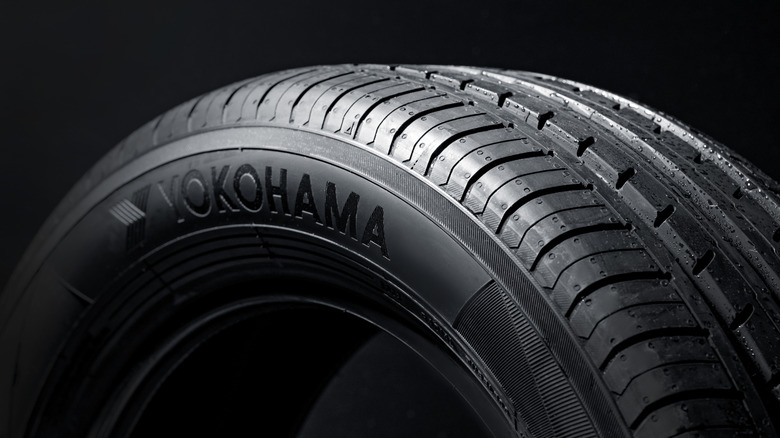 Close-up of Yokohama tire on black background, with logo visible