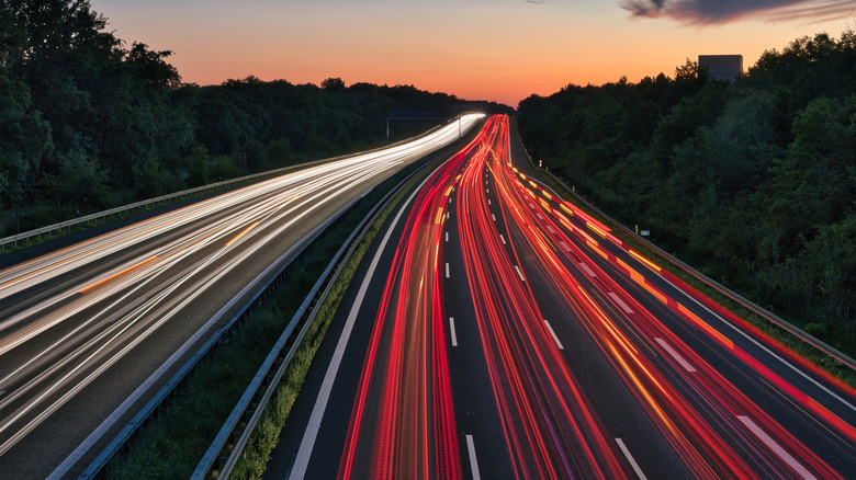Streaks of lights from cars driving on a highway.