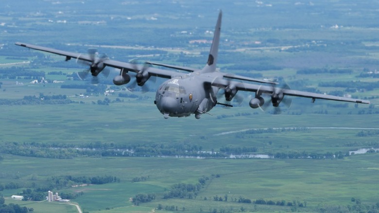 AC-130J Ghostrider flying over rural land.