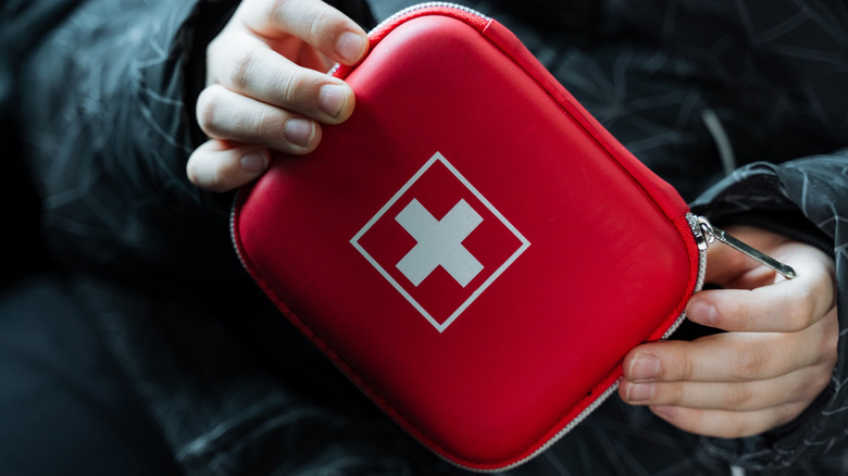 Person holding a first aid kit