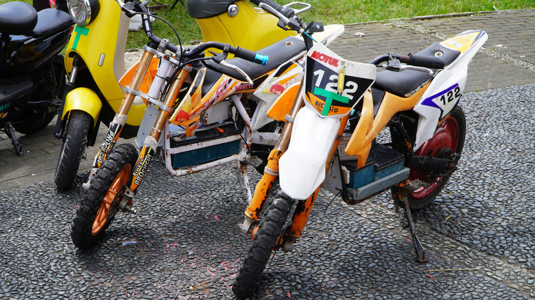 Three mini bikes parked at a pavement