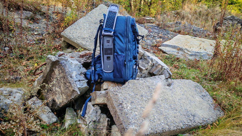 The Bluetti Handsfree 2 in the backpack with the side unzipped and its AC port on display.