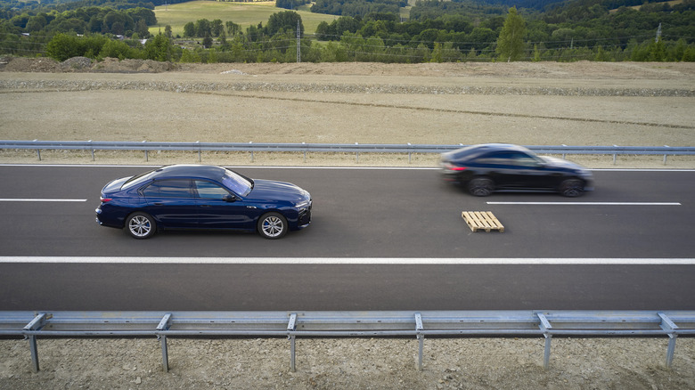 Self driving BMW stopping for wooden pallet