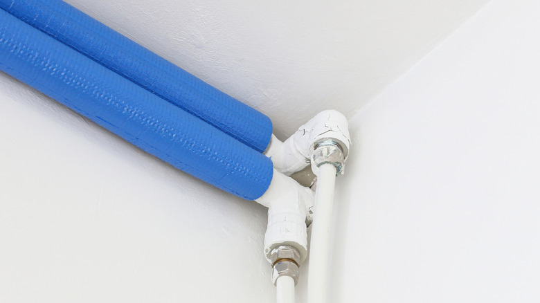 White pipes with blue insulation wrapped around them
